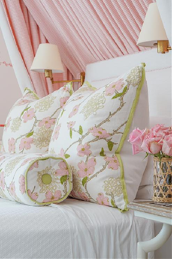white-bed-with-pink-and-green-floral-pillows