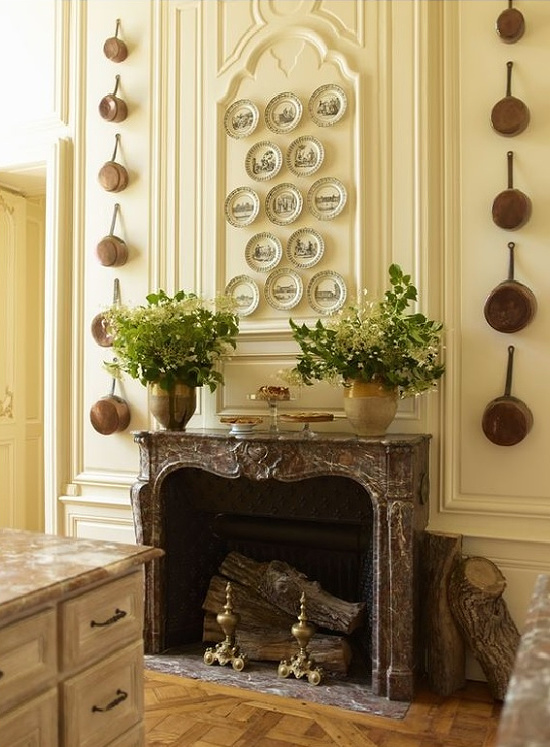 Timothy Corrigan Copper pots on kitchen wall