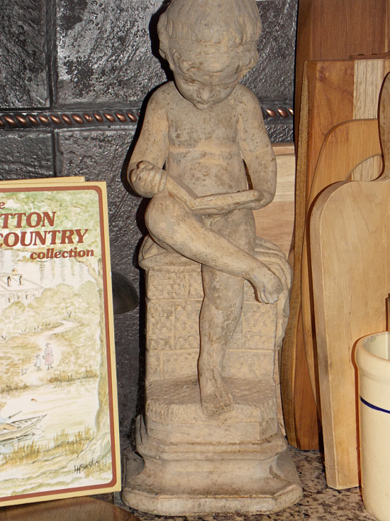 boy-reading-book-leg-crossed-garden-statue-2