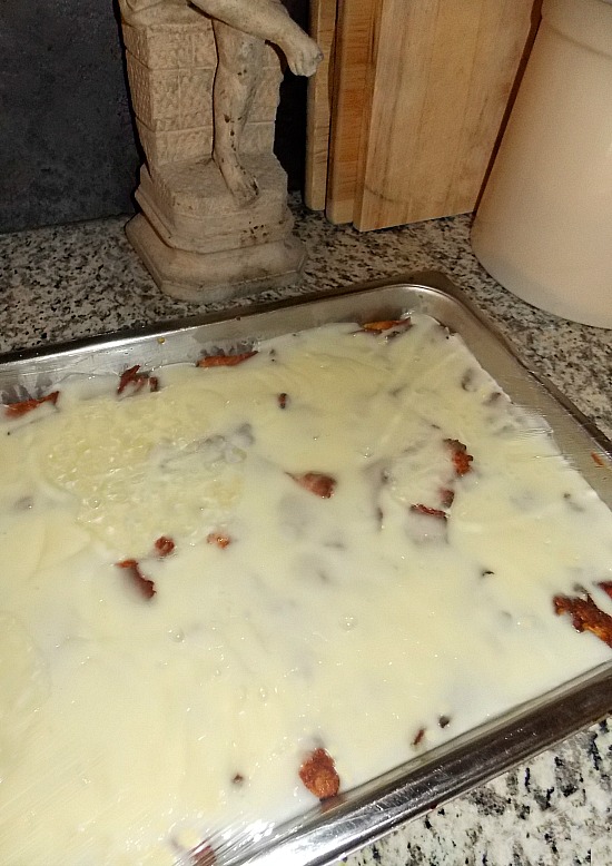 vanilla bread pudding with vanilla sauce in pan